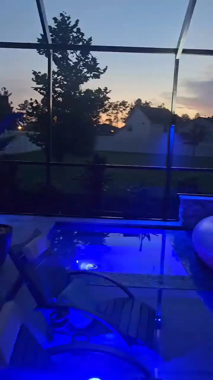 The whole pool enclosure run deep blue at night